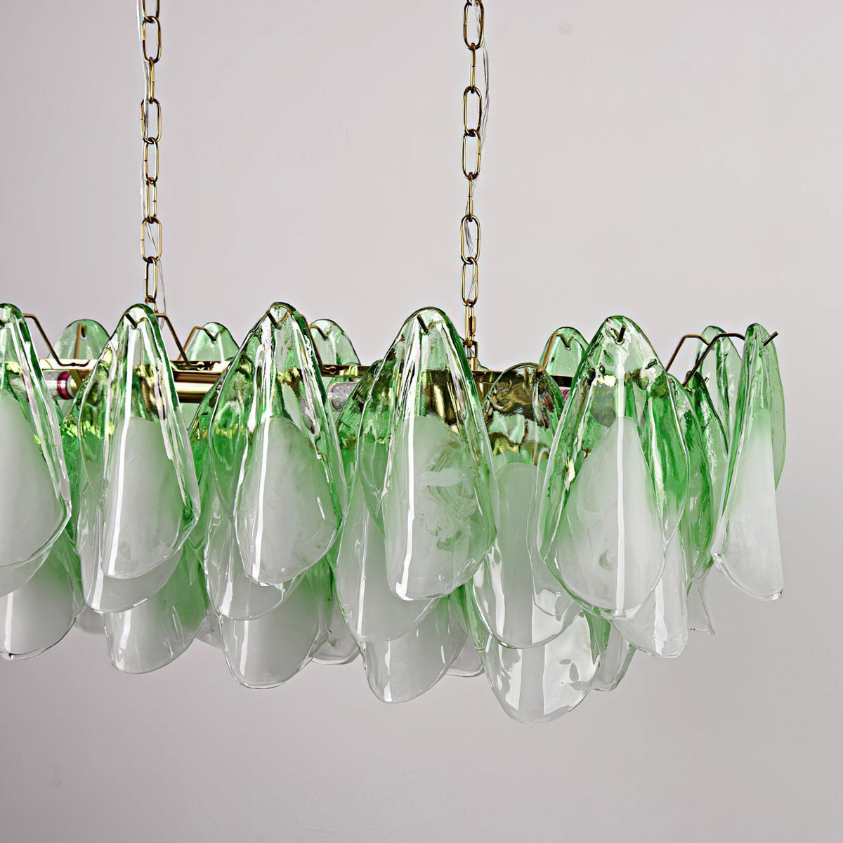 Angled view of the Flora chandelier showcasing its multi-tiered, oval design.