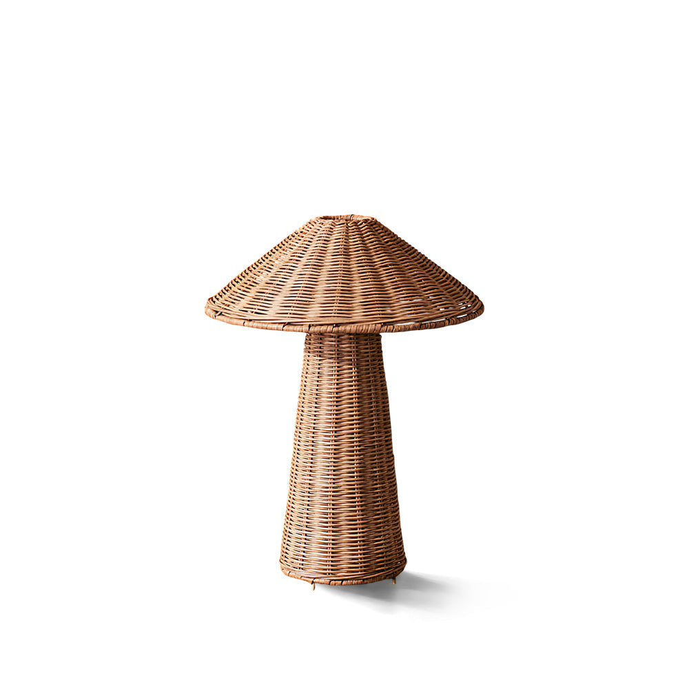 Freya Rattan Table Lamp with a mushroom silhouette on a wooden surface.