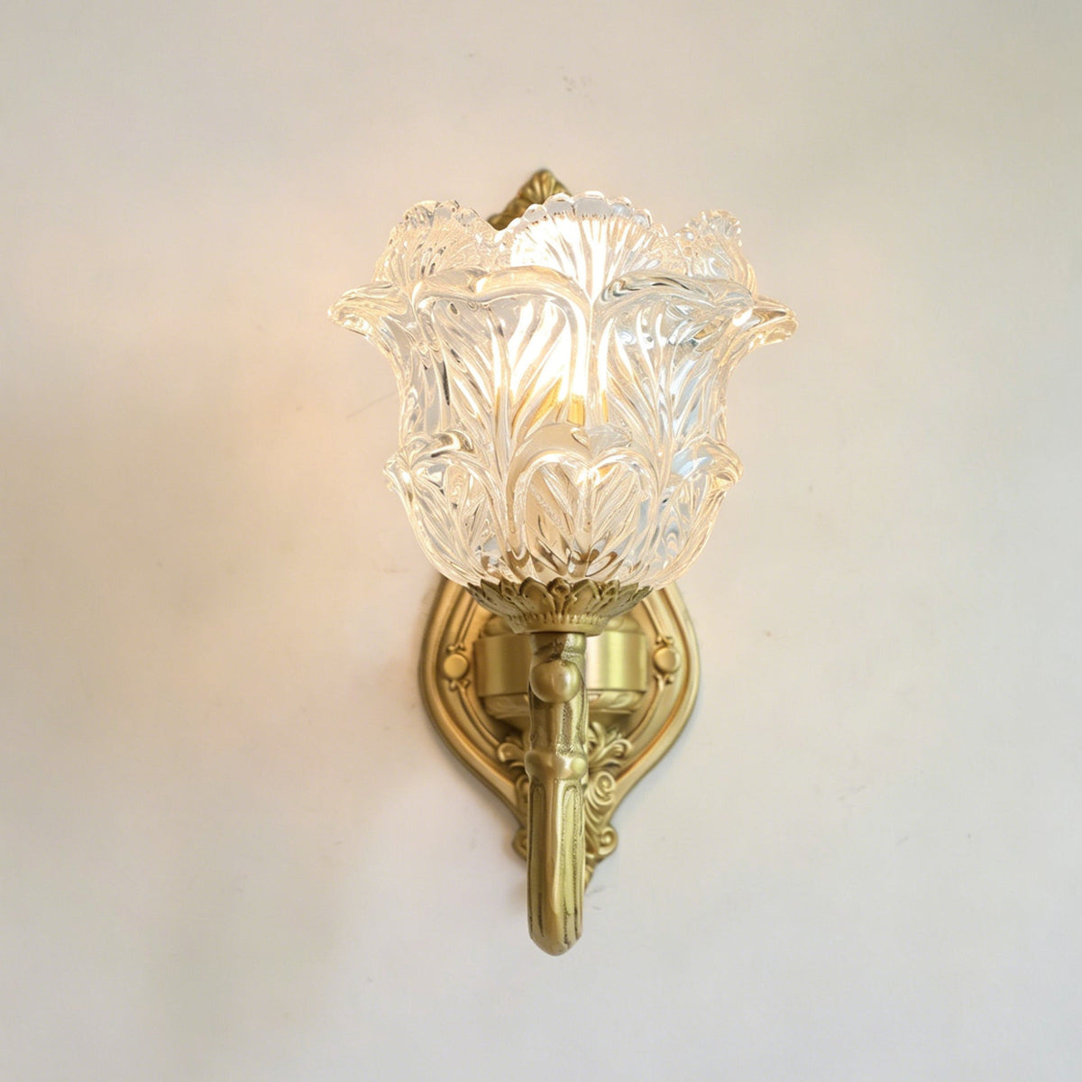 The Gideon sconce installed in a traditionally styled hallway next to a mirror.
