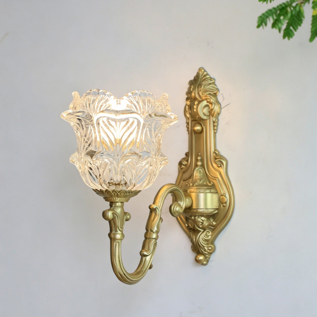 Detailed view of the ornate brass mounting plate and arm.