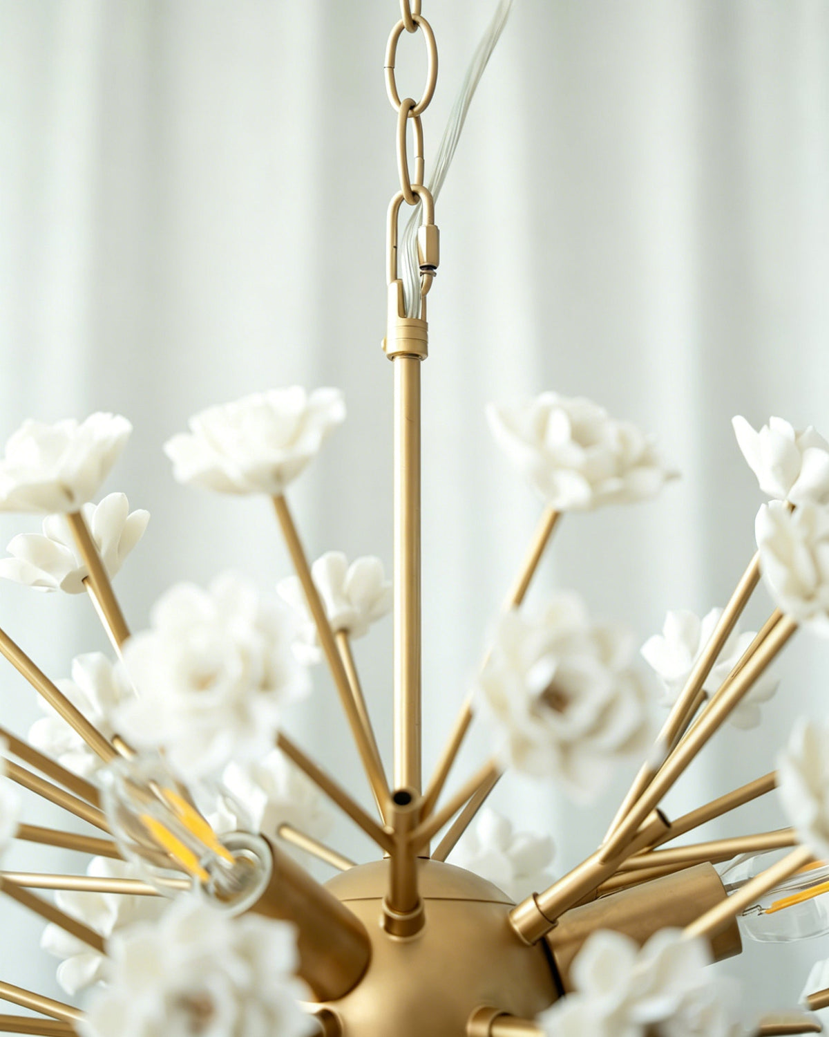Detailed view of the gold metal frame and ceramic floral elements.