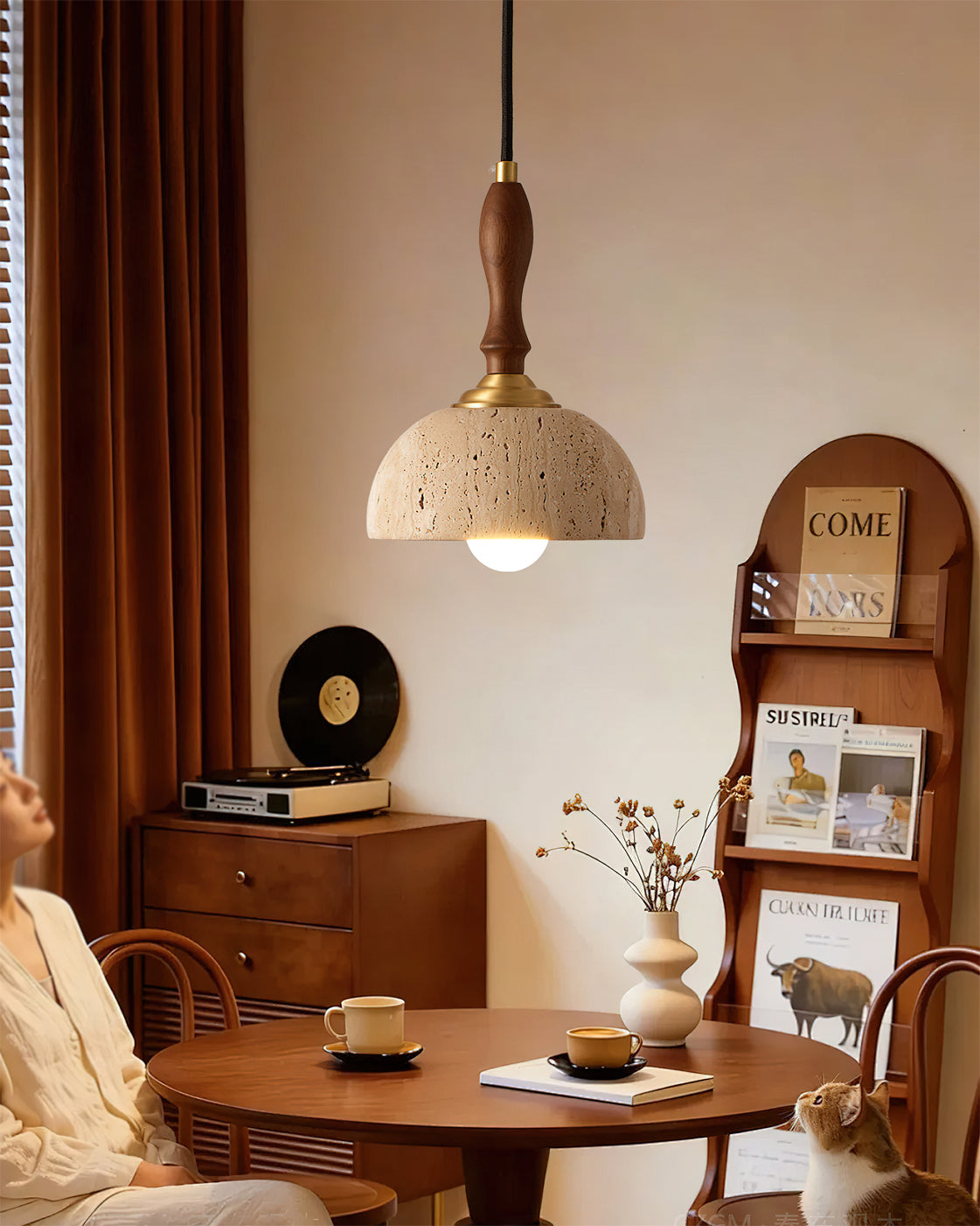The 3-light Enora Travertine Pendant Light hanging over a dining table.