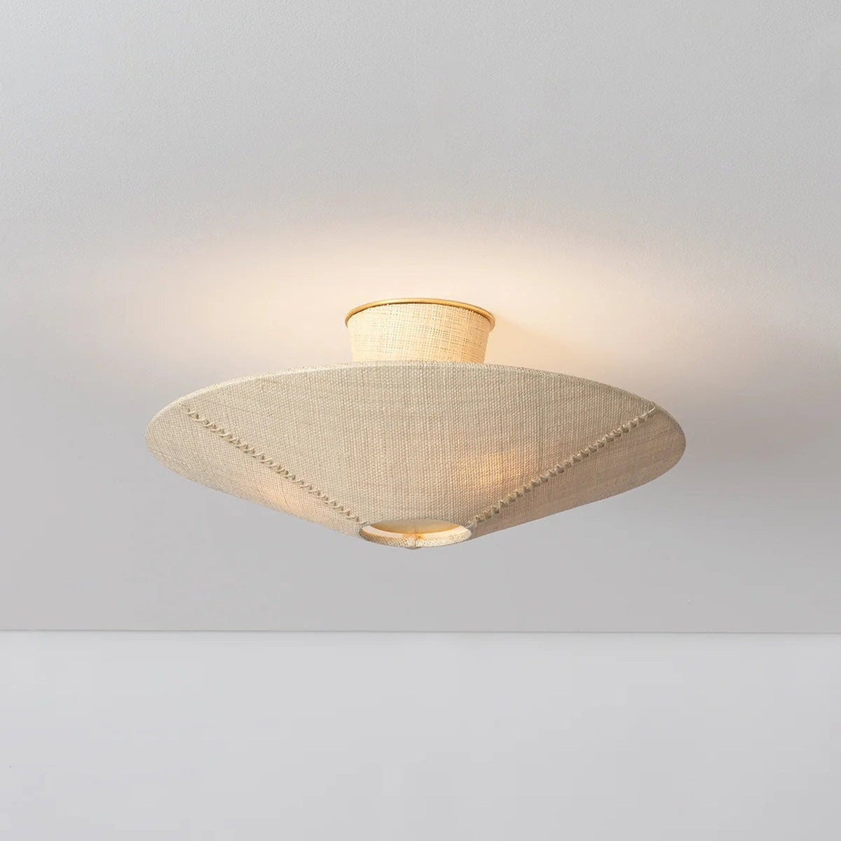 A close-up of the Ketan Semi Flush Mount's texture and whipstitched seam.