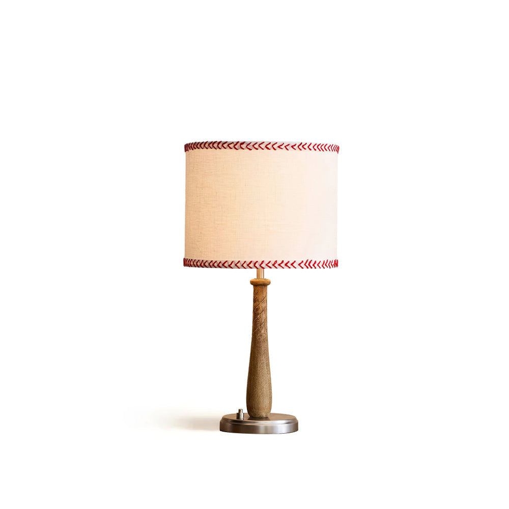 Mitchell Table Lamp with a baseball bat-shaped wooden base and white fabric shade.