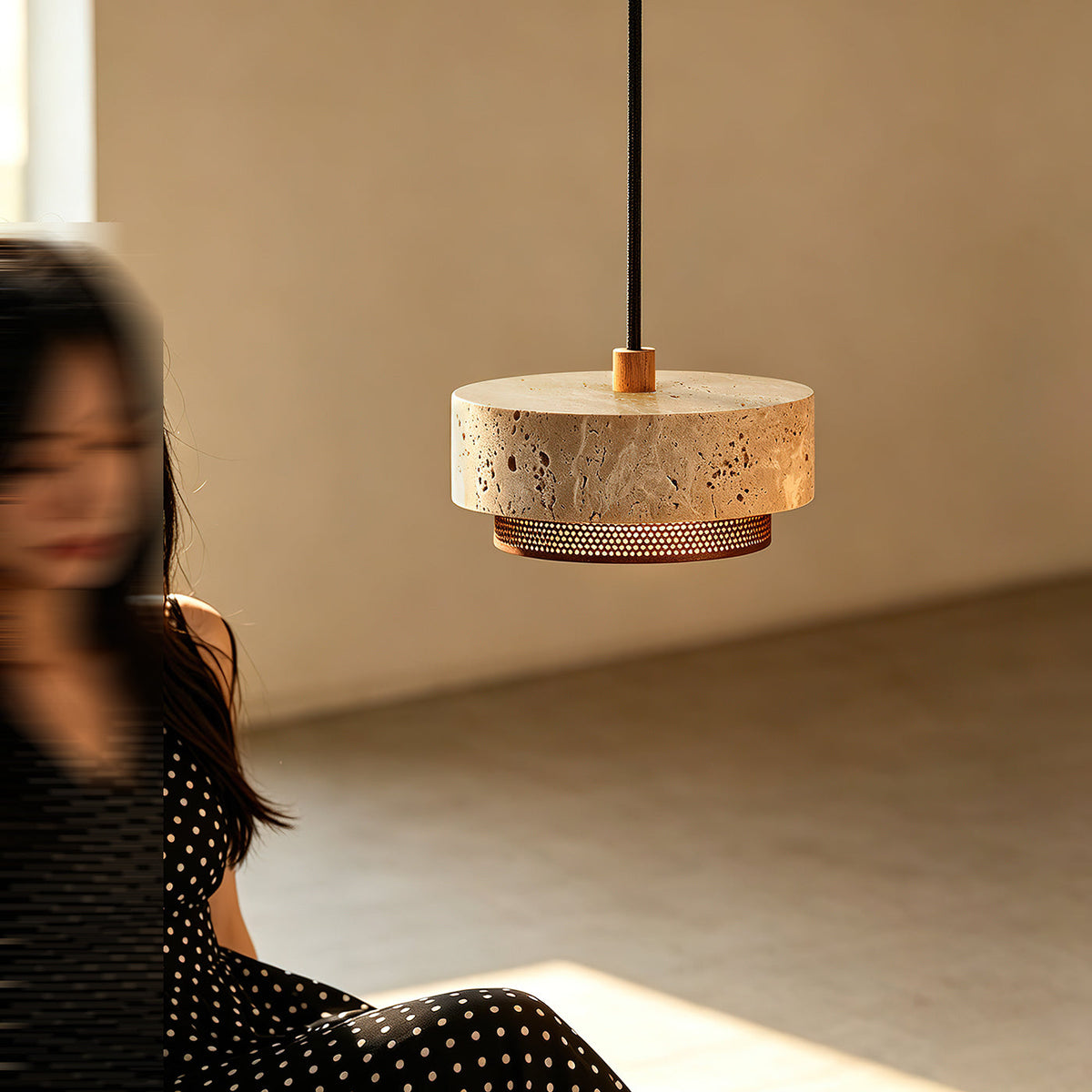 The 3-light Nolan Pendant Light version with walnut accents over a dining table.
