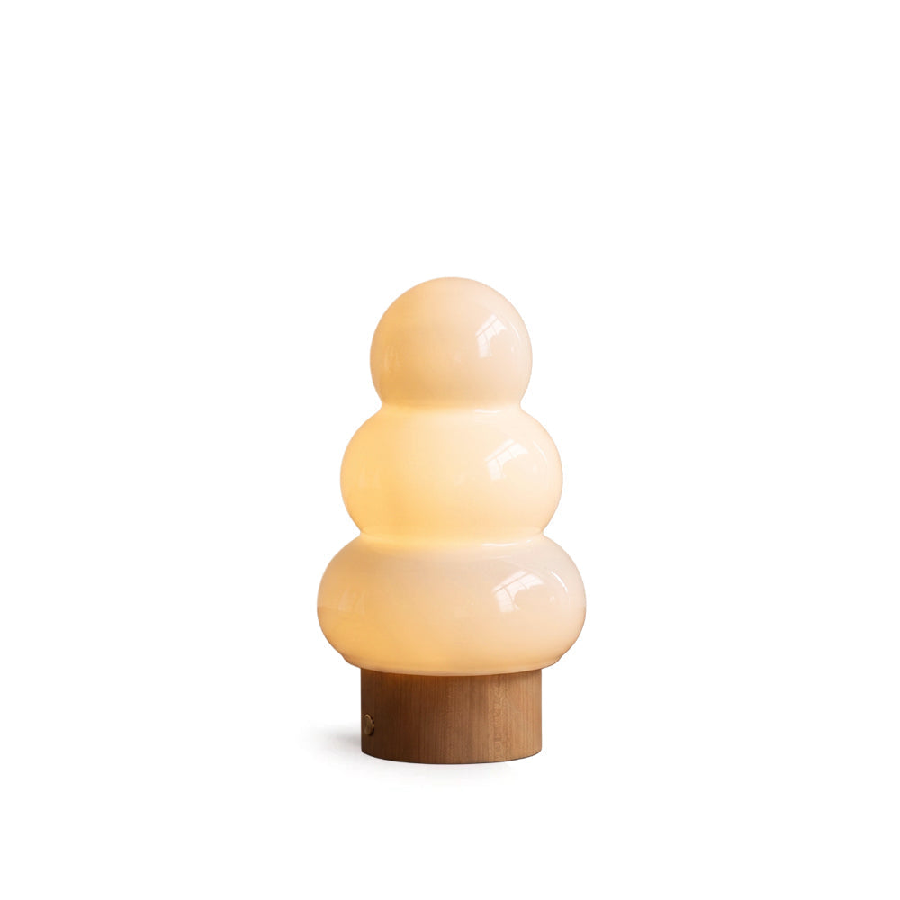 Orlo Ceramics Table Lamp with a stacked glass shade on a wood base.