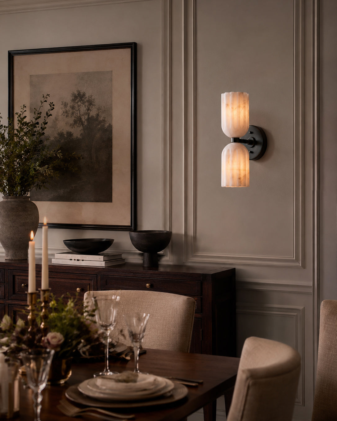 The alabaster wall sconce shown in a welcoming entryway setting.
