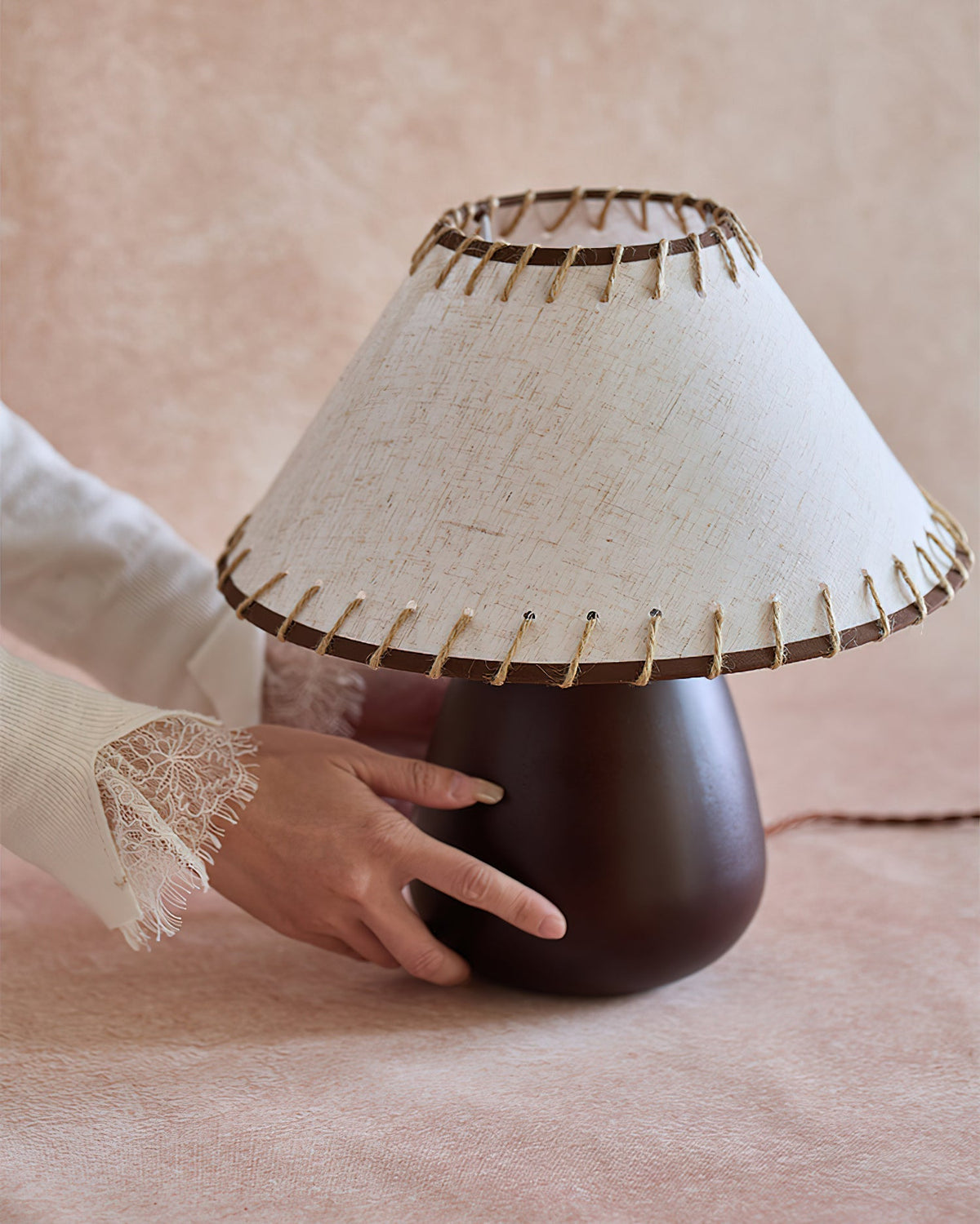 The smooth, rounded dark walnut wood base of the Douglas Table Lamp.
