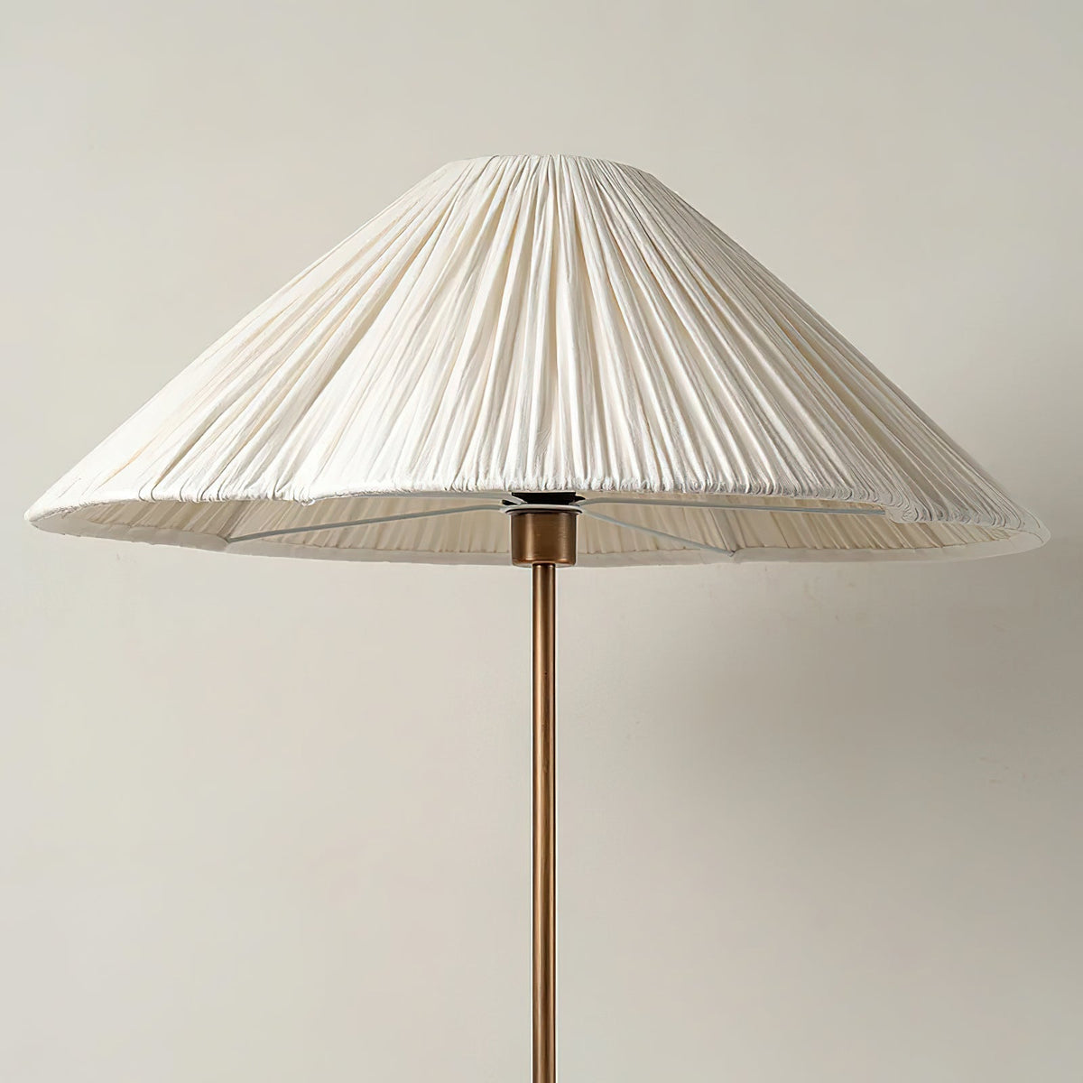 Sierra Linen Floor Lamp shown in a cozy living room setting next to a sofa.