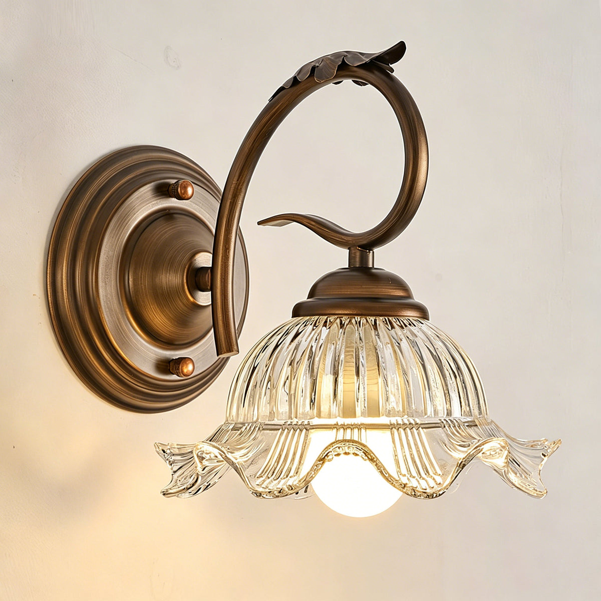 Close-up of the Sutton Wall Sconce's scalloped glass rim.