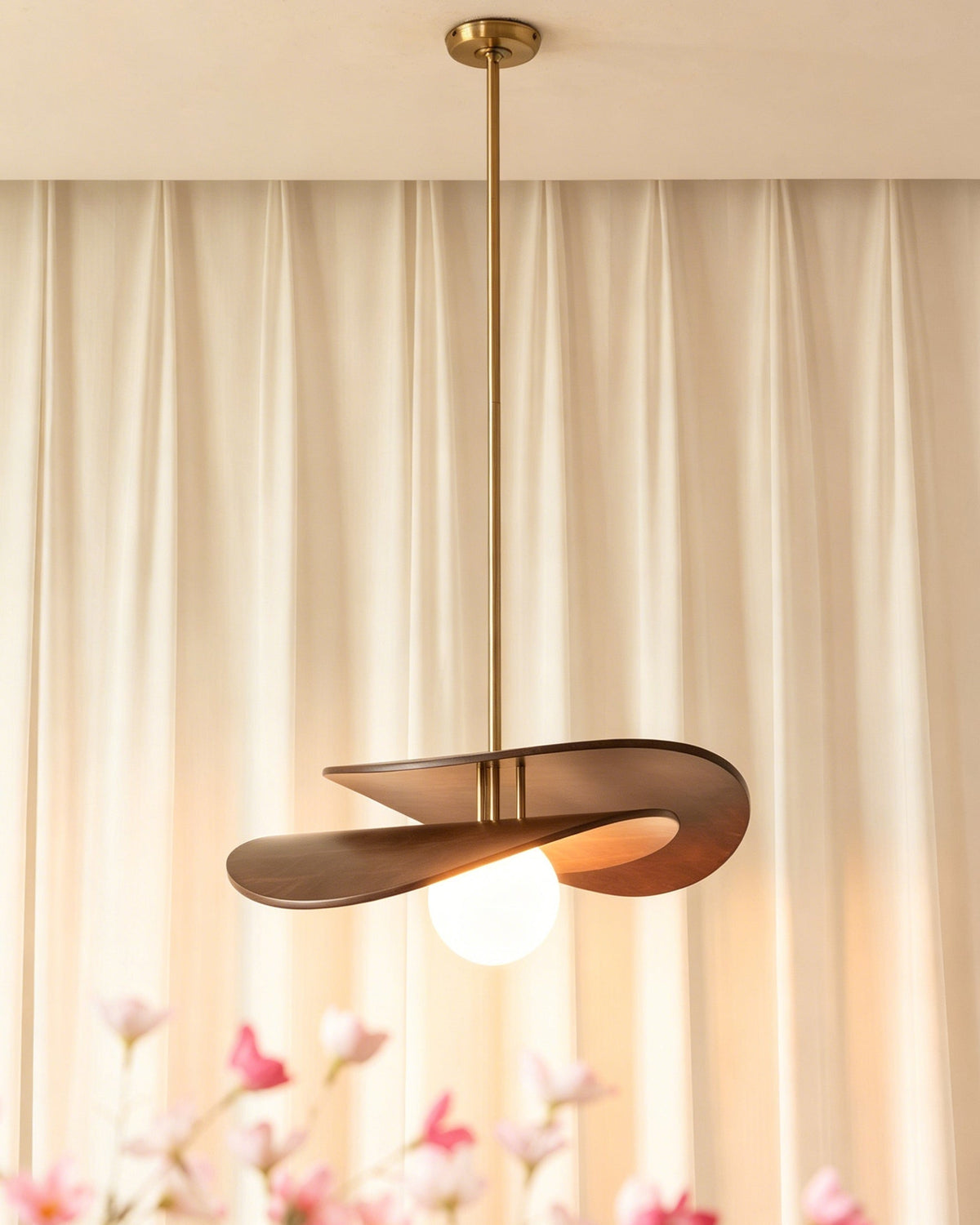 The Zane pendant light illuminated, casting a warm and inviting glow.