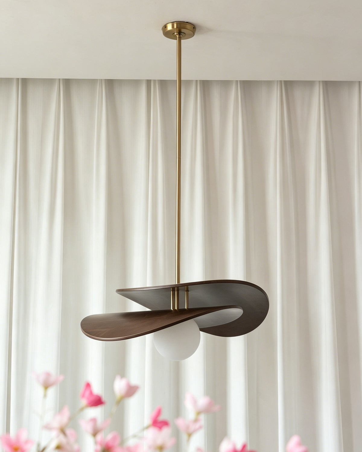 Lifestyle image of the Zane pendant light in a mid-century modern living room.