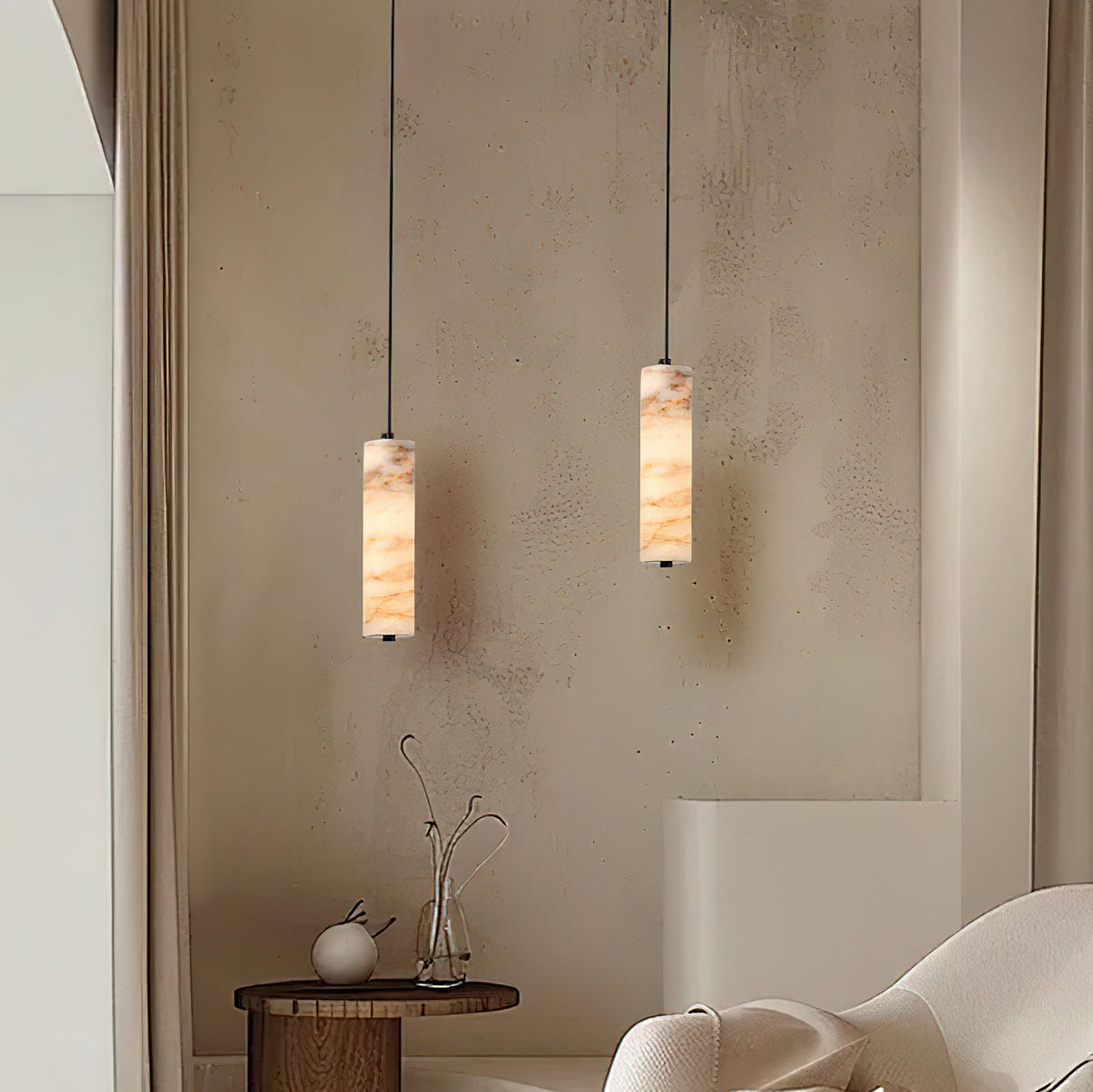 Devane Alabaster Pendant Light shown lit, casting a warm and diffused glow.