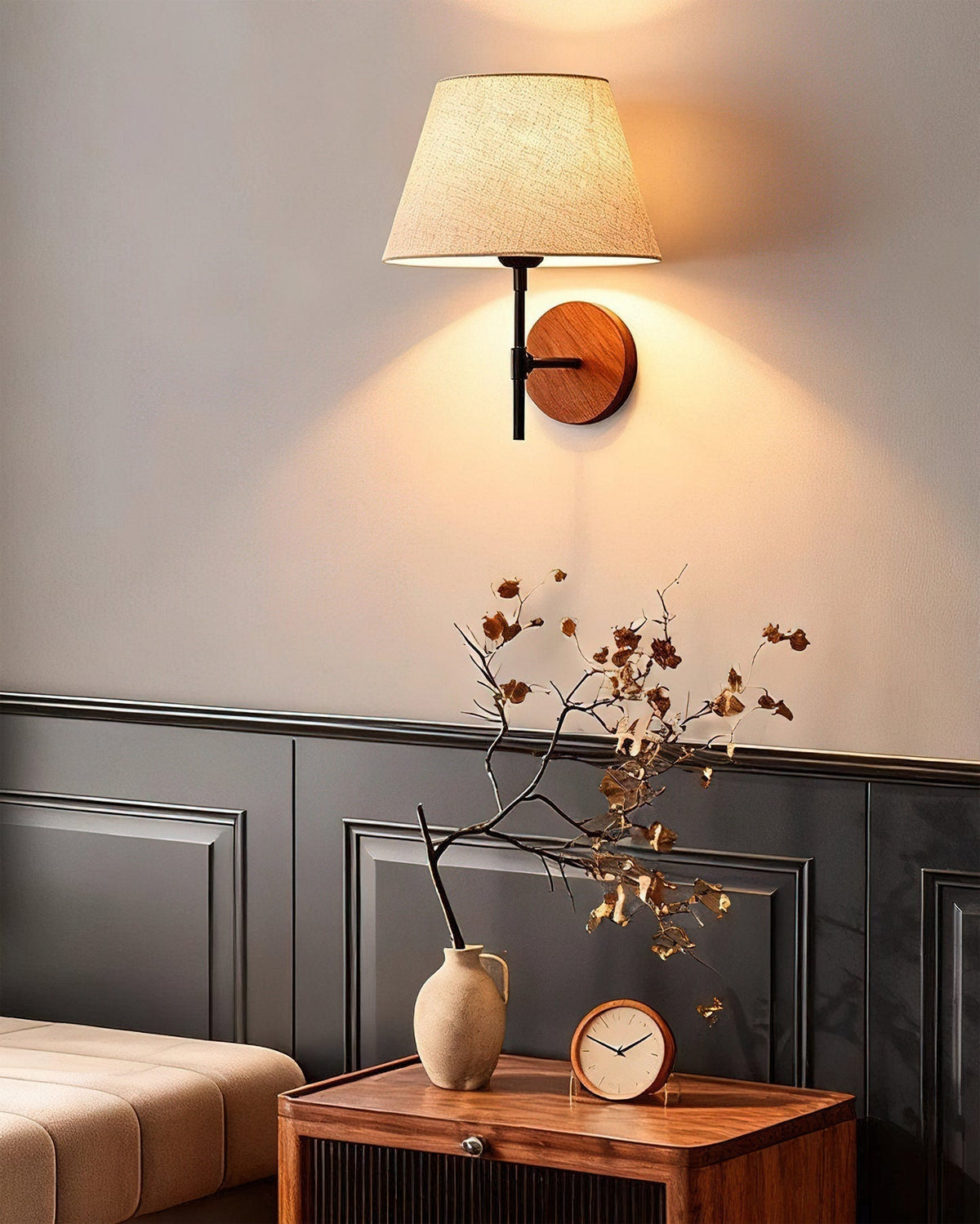 Angled view of the Dodie Wall Light, highlighting its metal mounting plate.