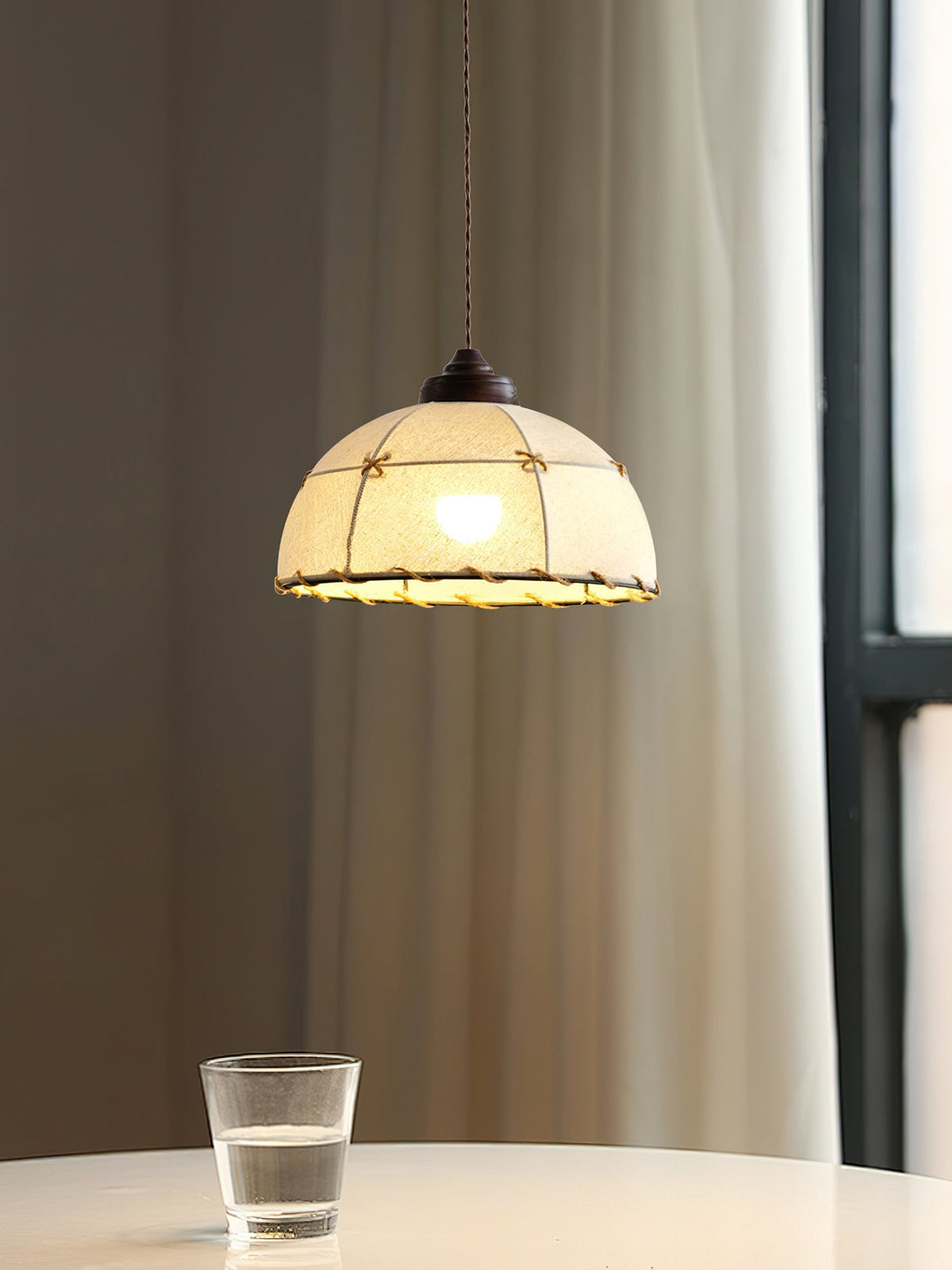 Detail shot of the walnut-colored wood and metal frame of the Duomo Pendant Light.
