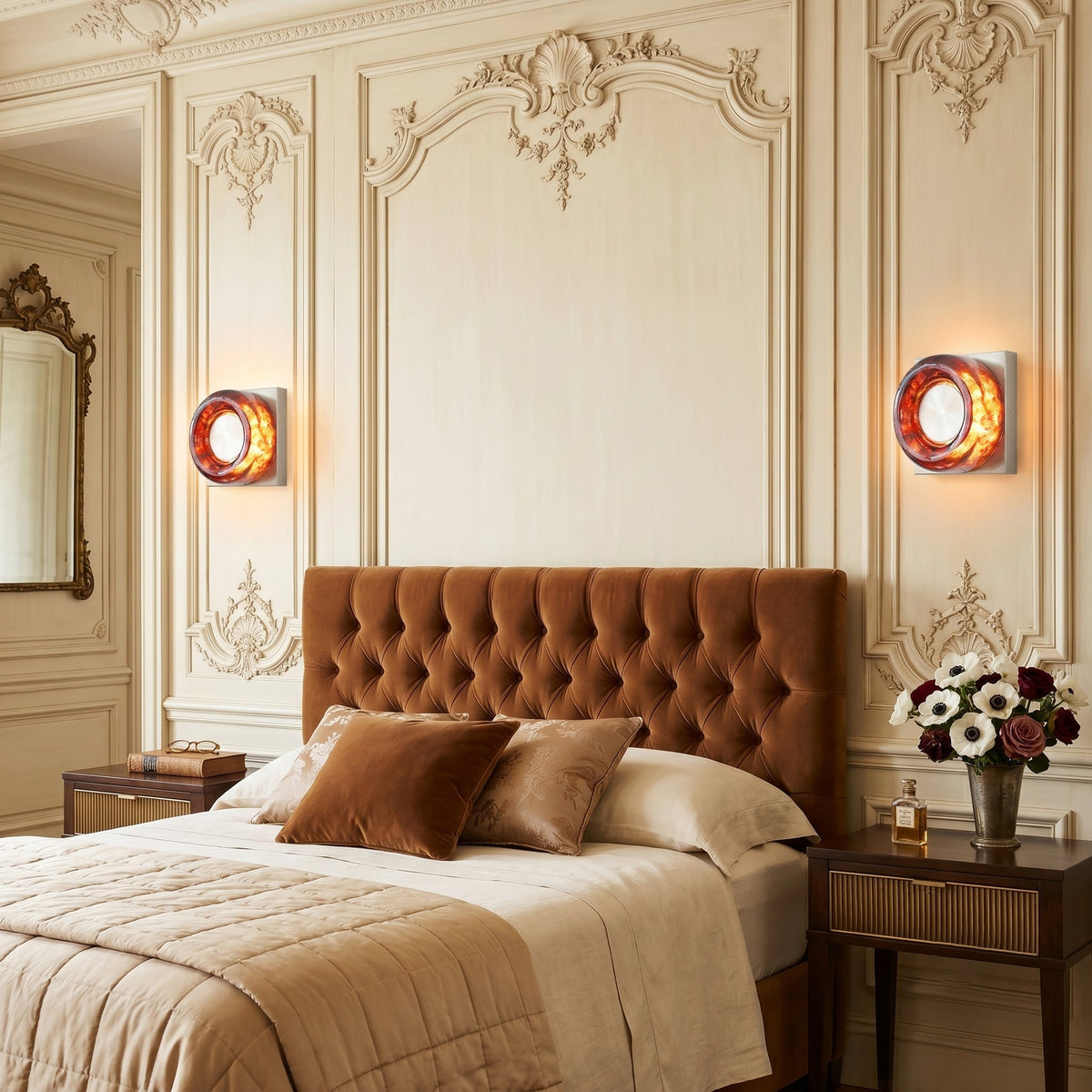The Eisner Wall Sconce mounted on a bedroom wall, providing reading light.