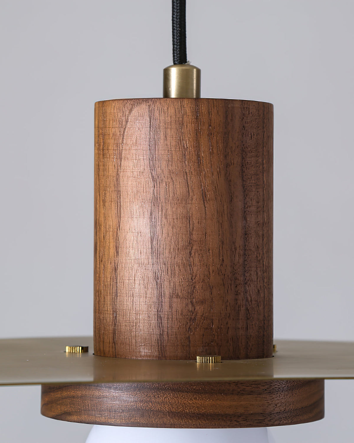 The Elara Pendant Lamp providing warm light over a contemporary dining table.