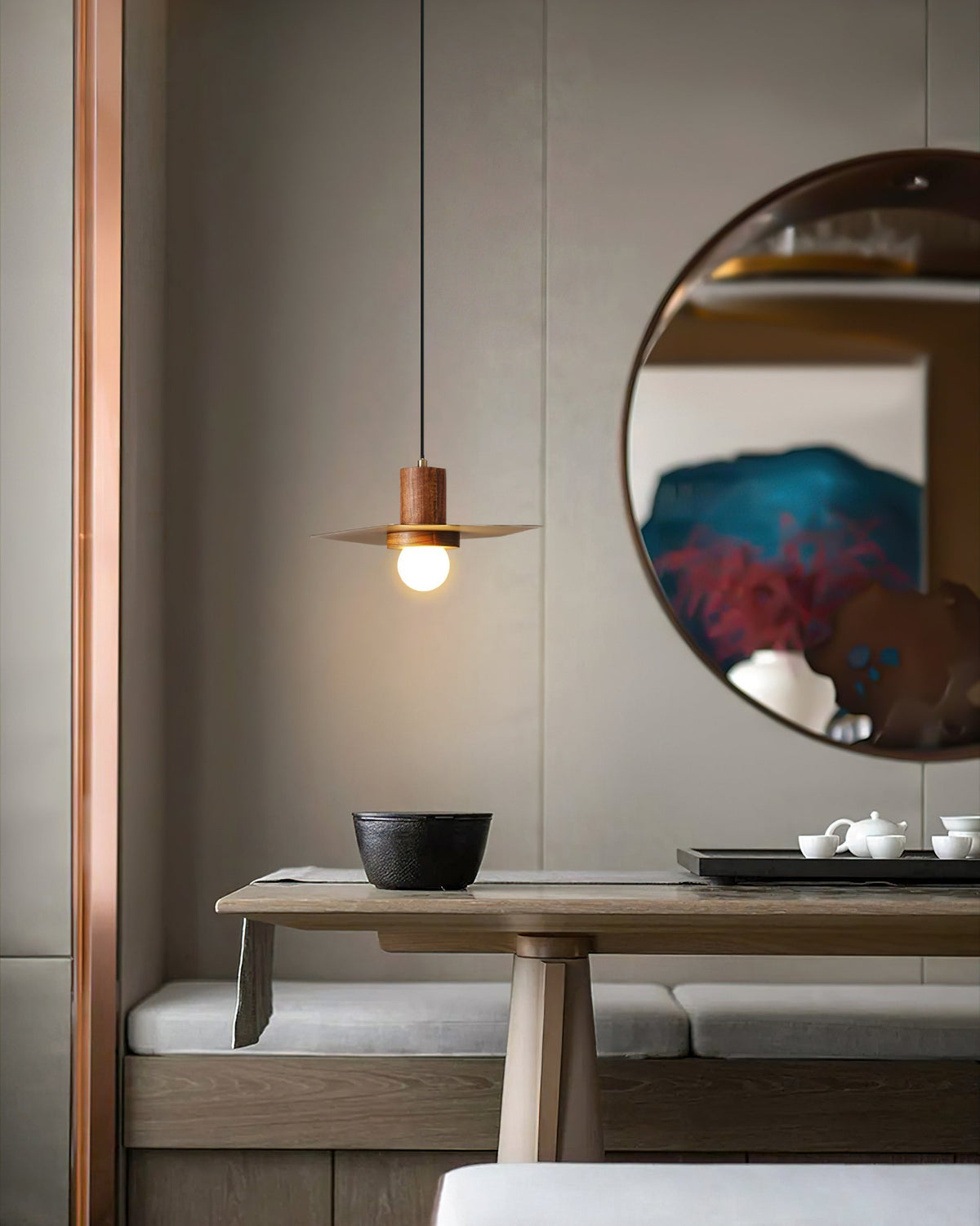 Detail shot of the natural wood ceiling mount and black suspension cord.
