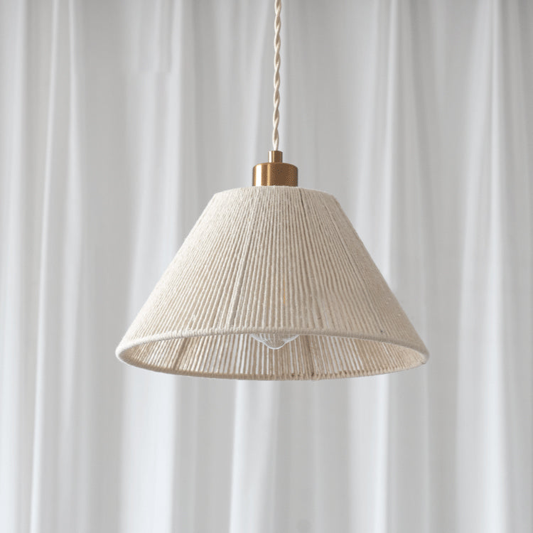 Detail shot of the Elara pendant's gold ceiling canopy and suspension wire.