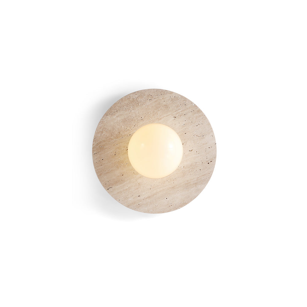 Elira Travertine Wall Lamp with circular stone base and glowing glass orb.