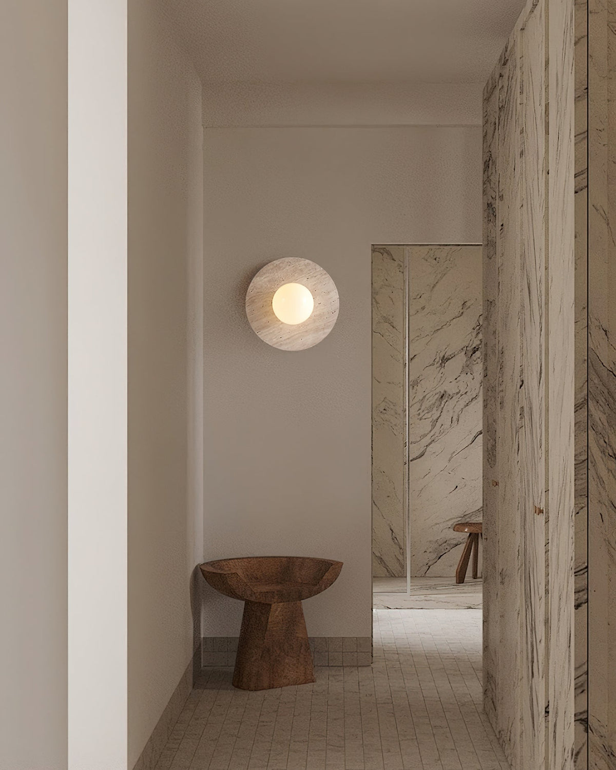 Detail shot of the glass sphere and its connection to the travertine base.