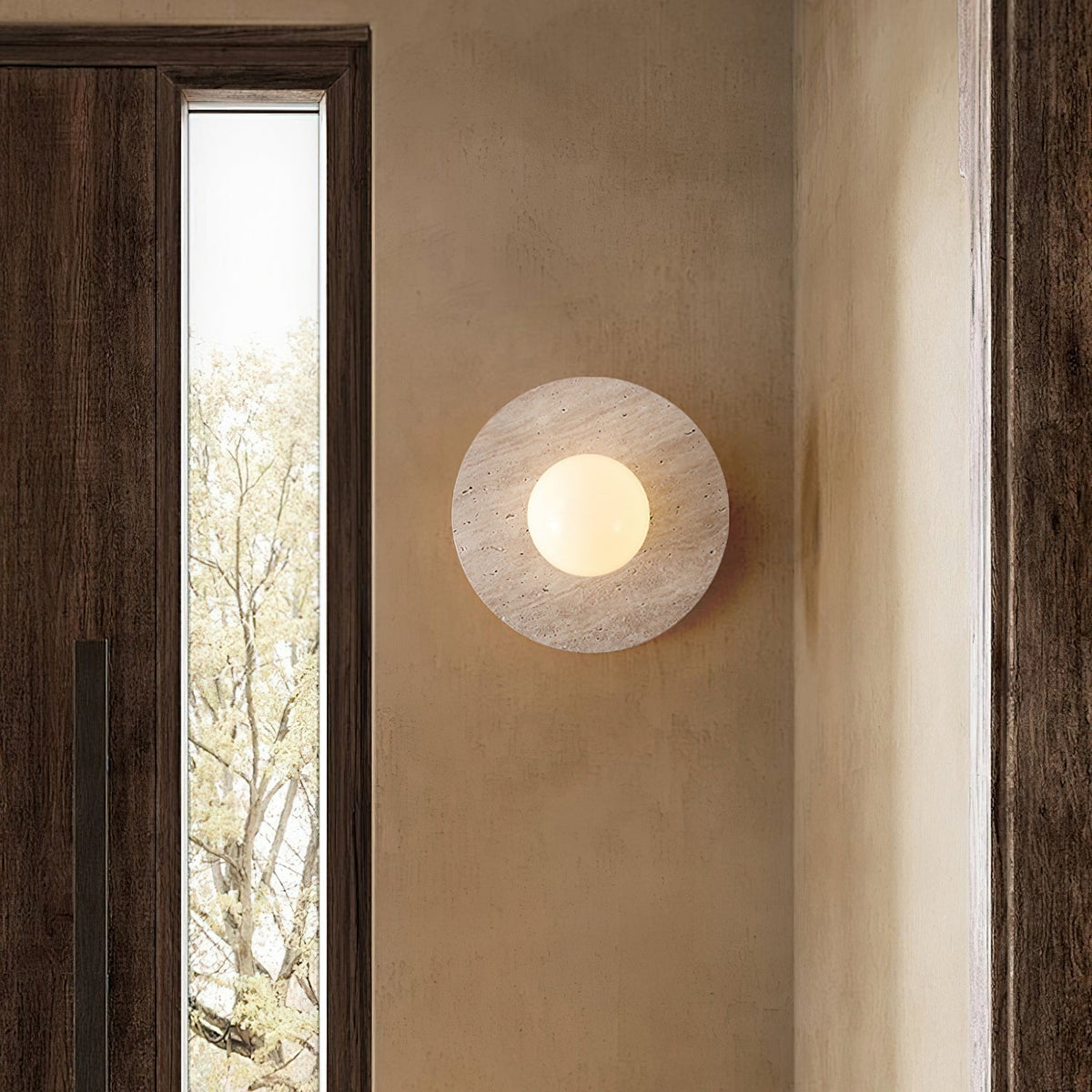 Close-up of the natural travertine texture on the Elira Wall Lamp.