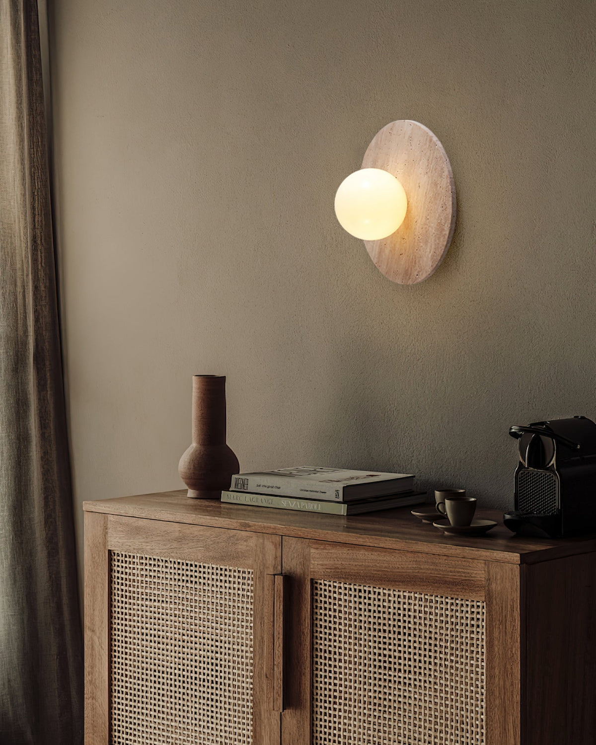 Elira Wall Lamp in a dimly lit room, showcasing its warm, ambient glow.