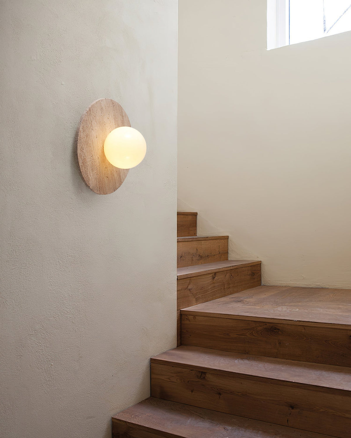 Side view of the Elira Wall Lamp, highlighting its profile and glass sphere.