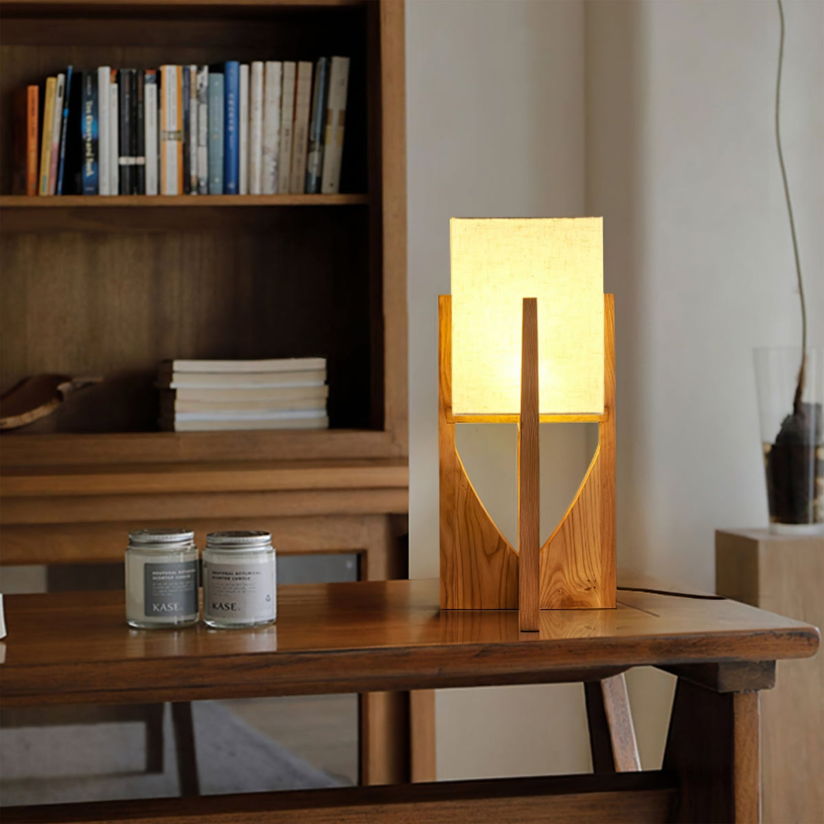 Close-up view of the Fairbanks Table Lamp's wooden base and white shade.