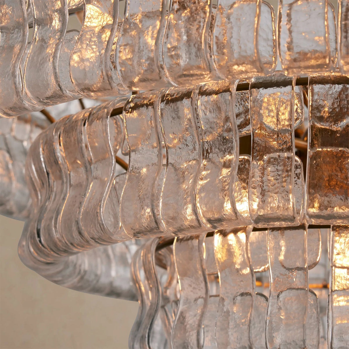 The Ghiaccio Chandelier casting patterns of light on the ceiling.