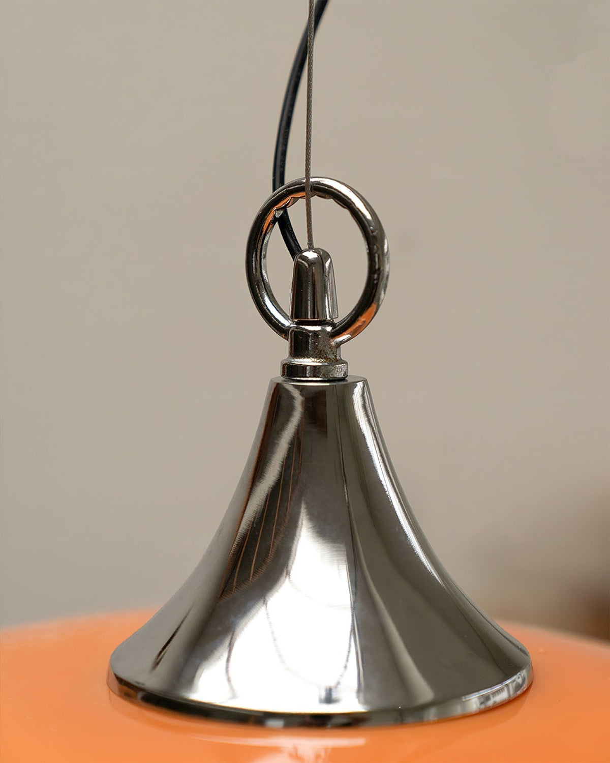 The pendant light shown against a dark background to highlight its color.