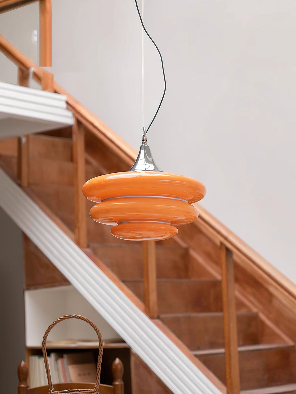 The Gispen Orange Pendant Light illuminating a dining table.