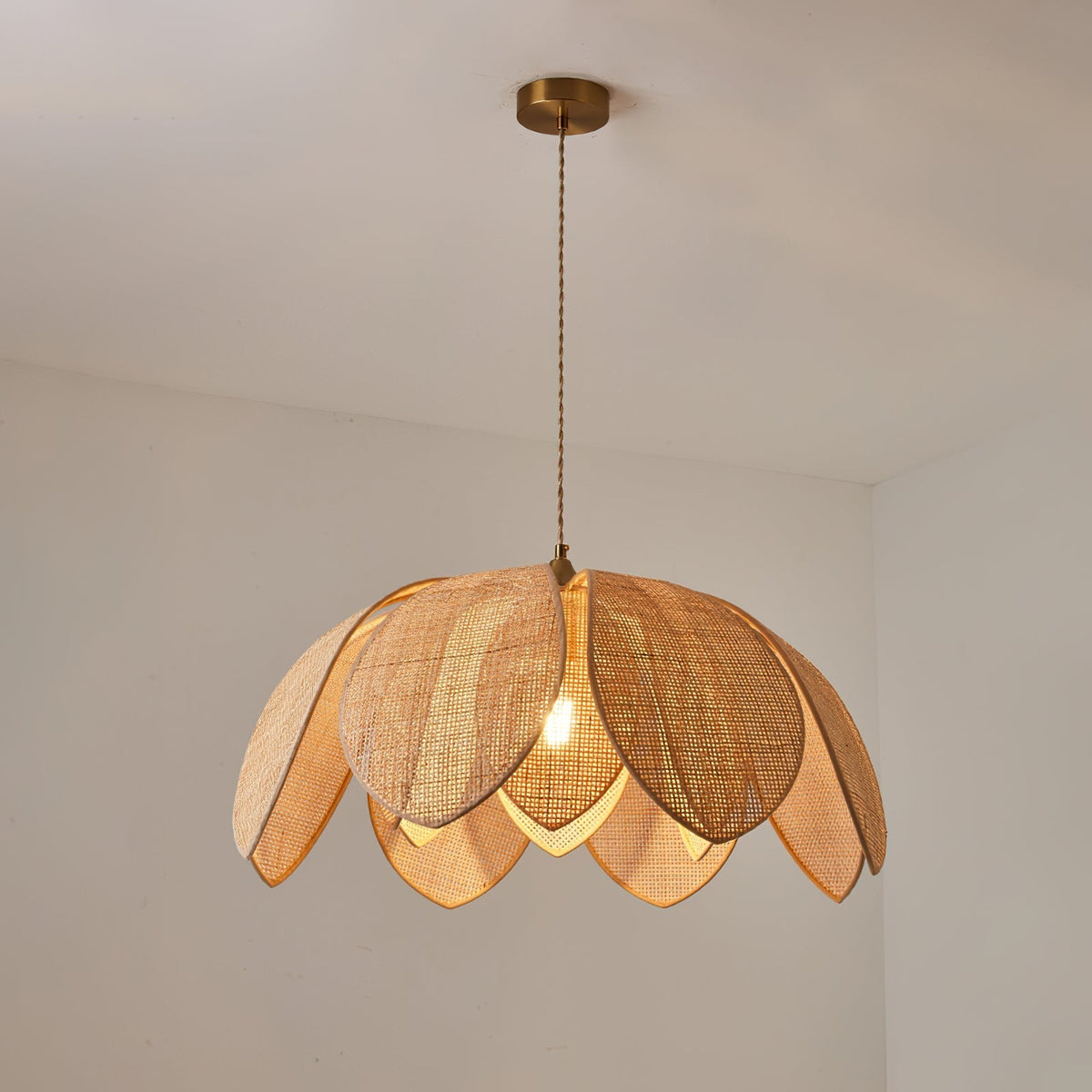 The medium-sized Hanove Pendant Light hanging over a kitchen island.