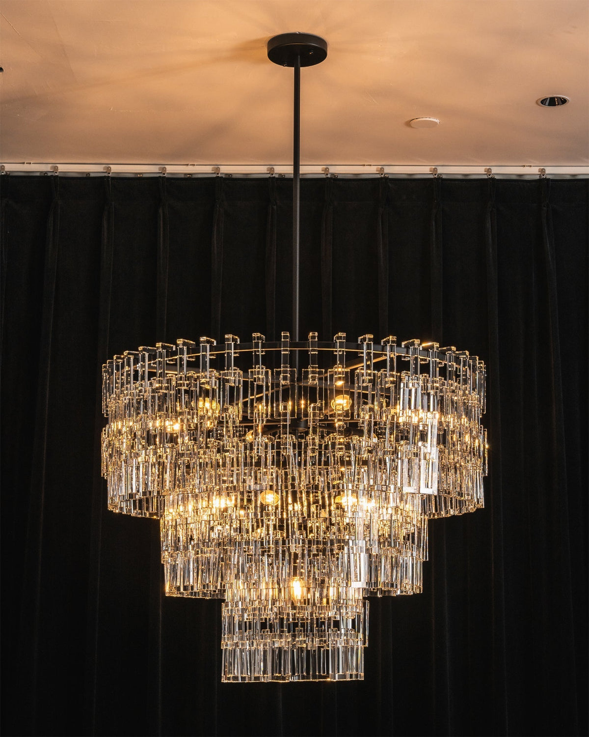 Harlow Chandelier with lights turned on, creating a sparkling effect.