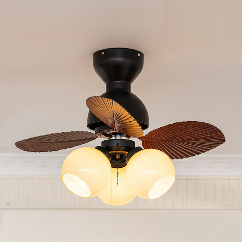 The Belize Ceiling Fan Light in walnut finish in an eclectic dining space.