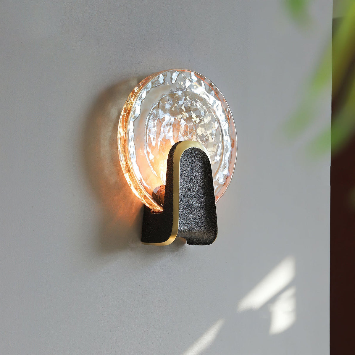 Close-up of the Ingot Wall Lamp's textured hand-cast glass.