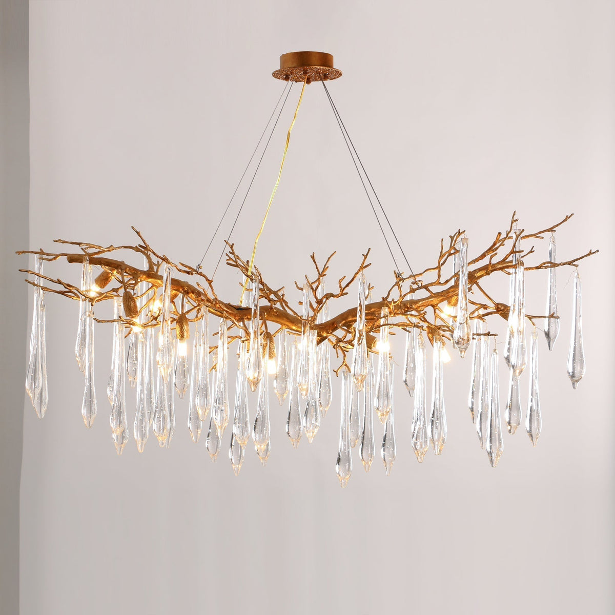 Close-up of the Janae Chandelier's glass shades and brass structure.