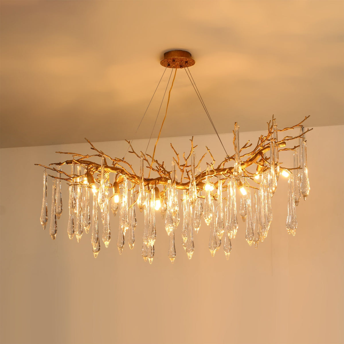 Janae Chandelier hanging in a modern living room, providing warm light.