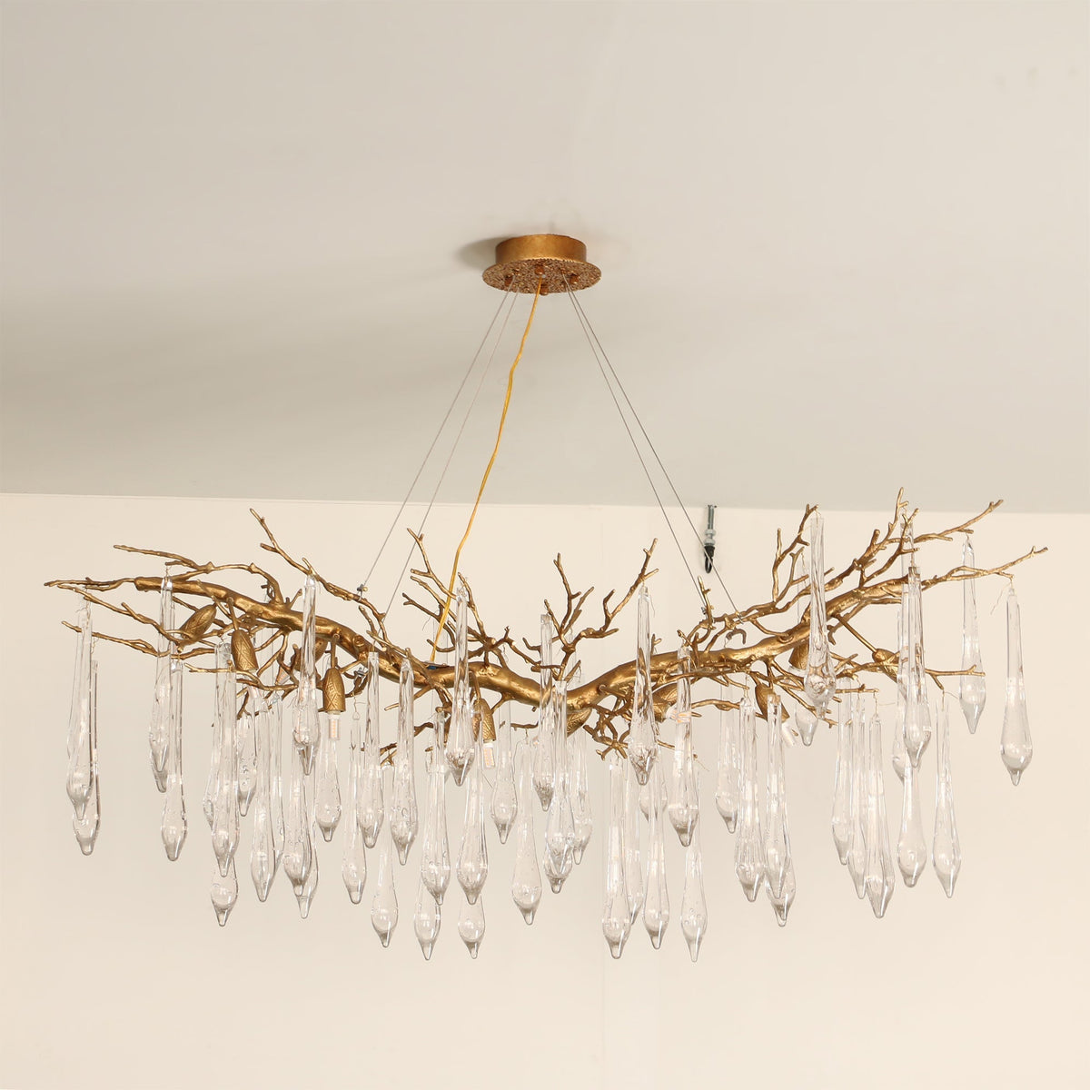 Angled shot of the Janae Chandelier, emphasizing its luxurious brass finish.