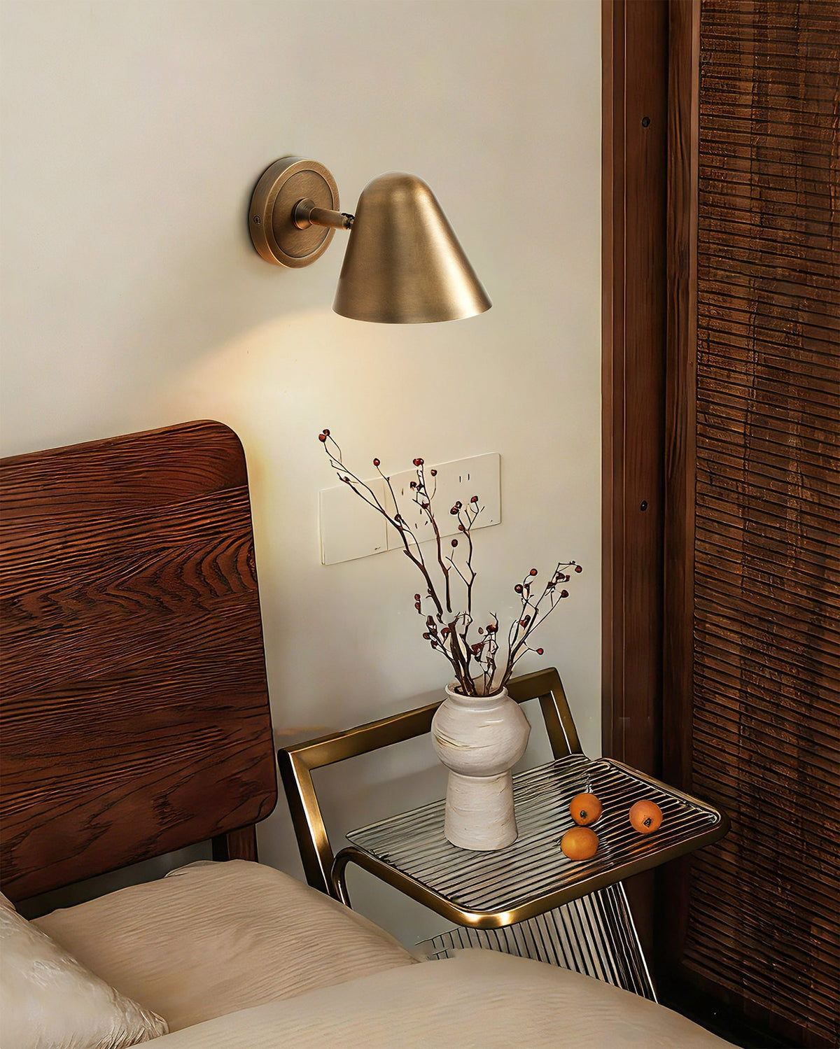 Janna Wall Lamp illuminated, casting a warm downward light.