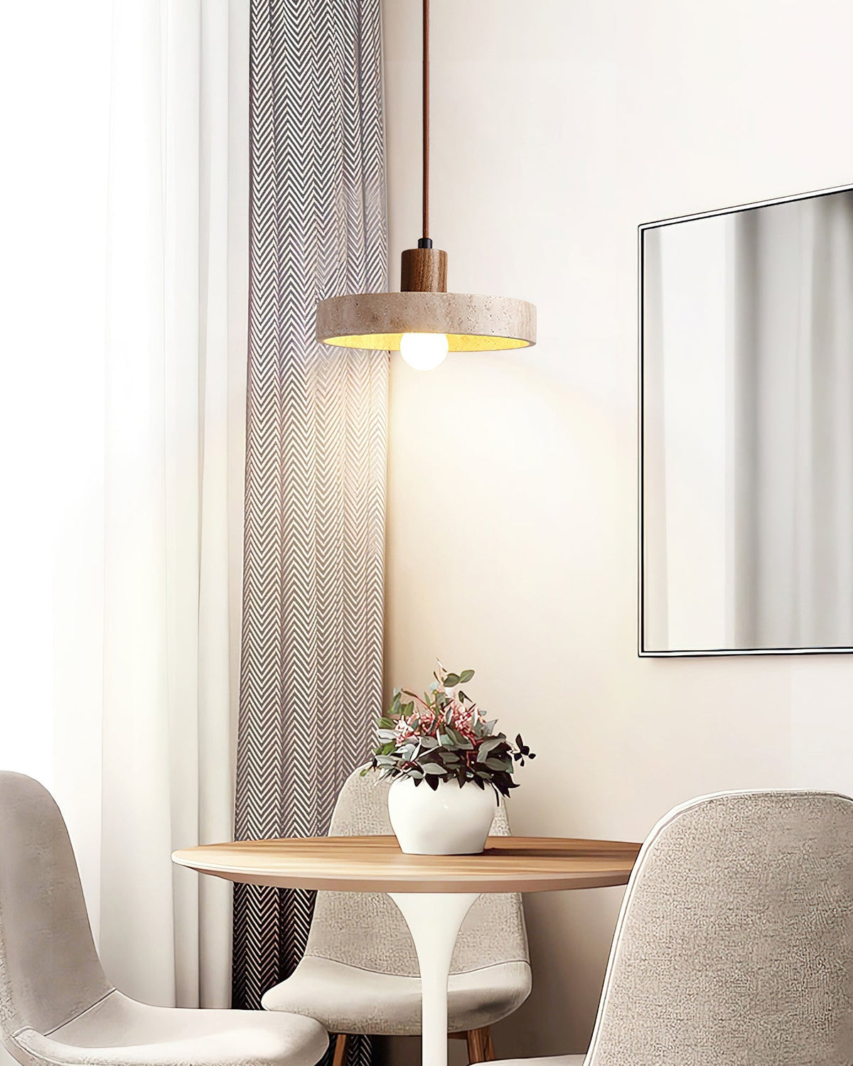 Kairi Pendant Lamp with three travertine shades over a dining area.