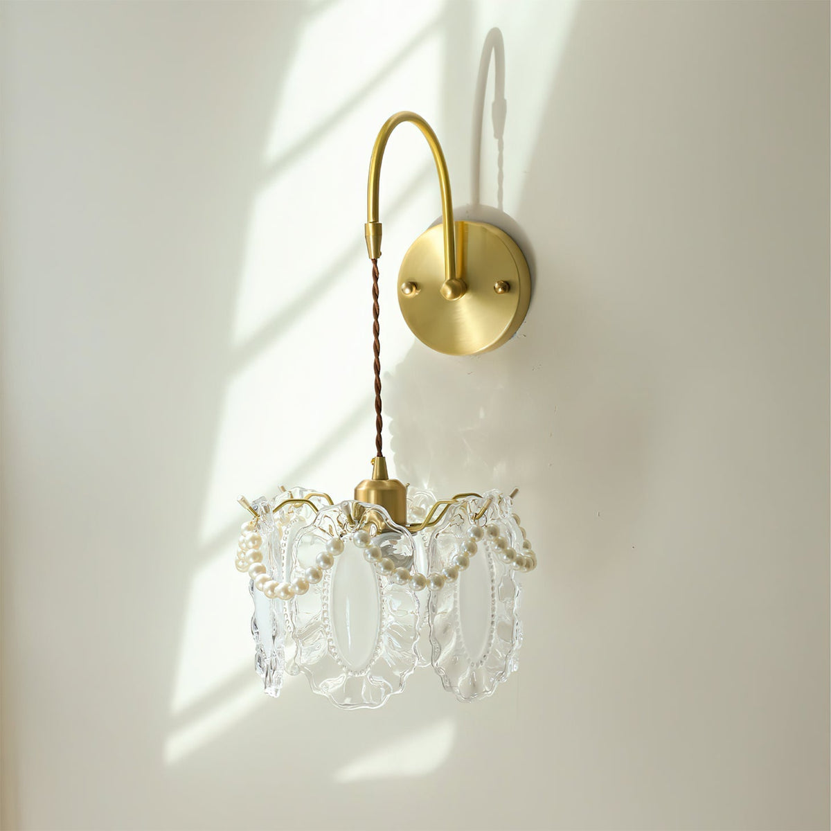 Lifestyle view of the Kano Glass Wall Light in a modern bedroom.