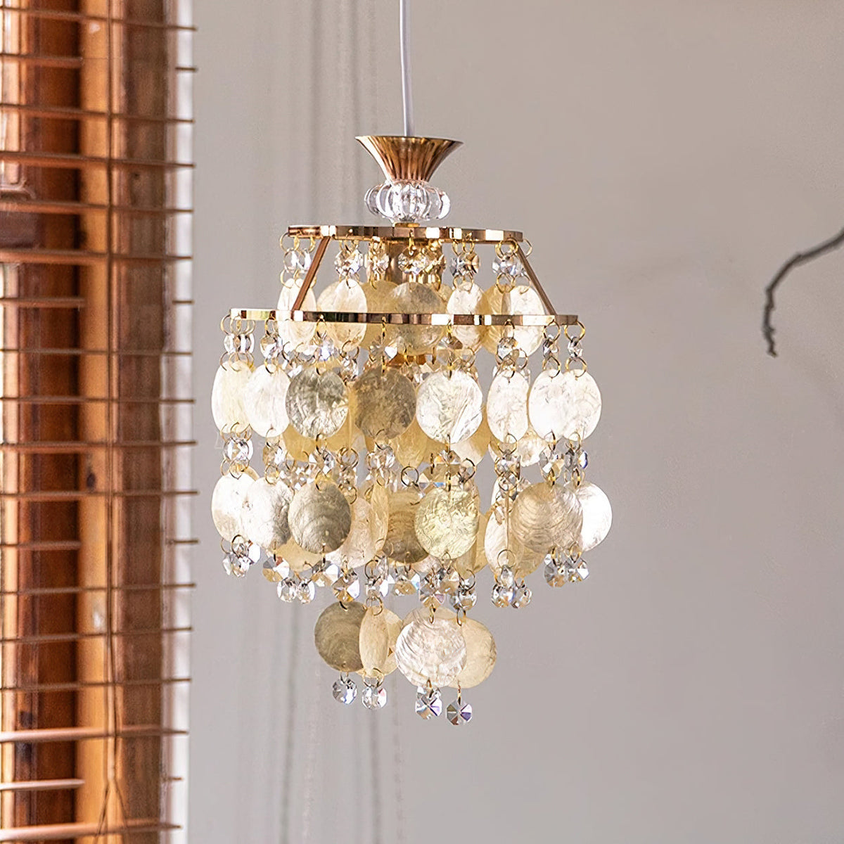 Close-up of the Katinka Pendant Light's capiz shell discs and crystal accents.