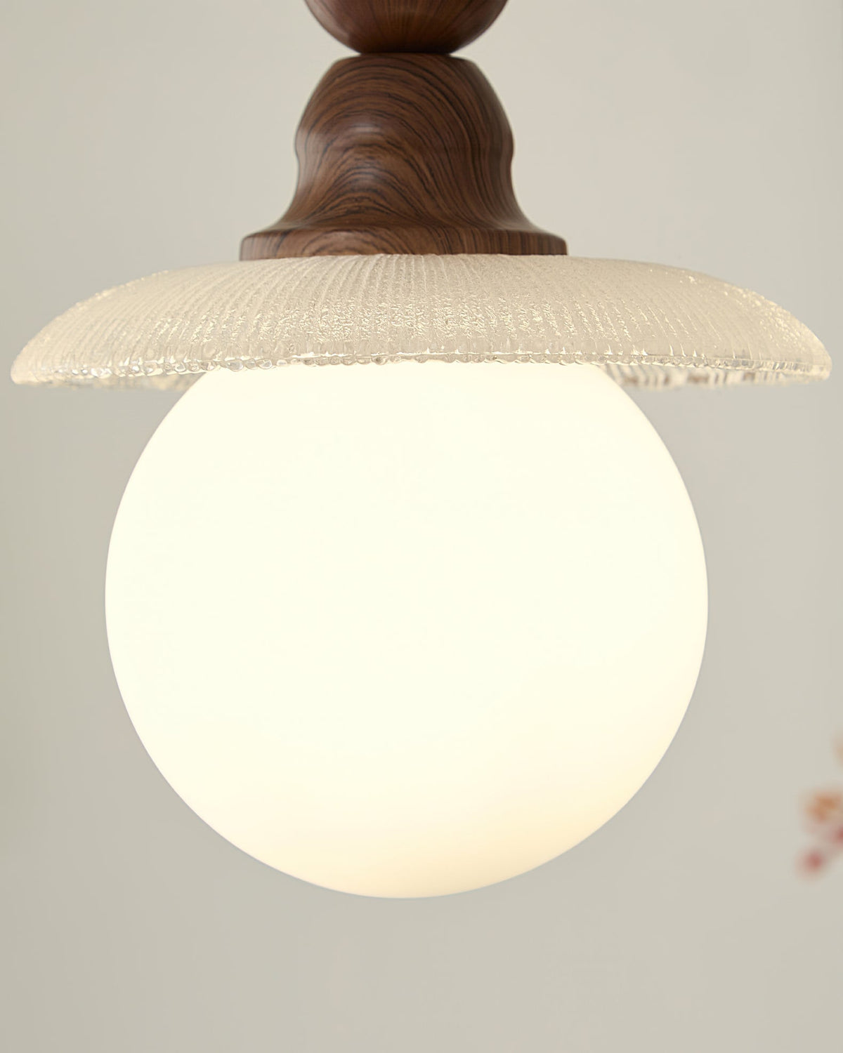 The clean light diffused through the white ribbed glass shade.
