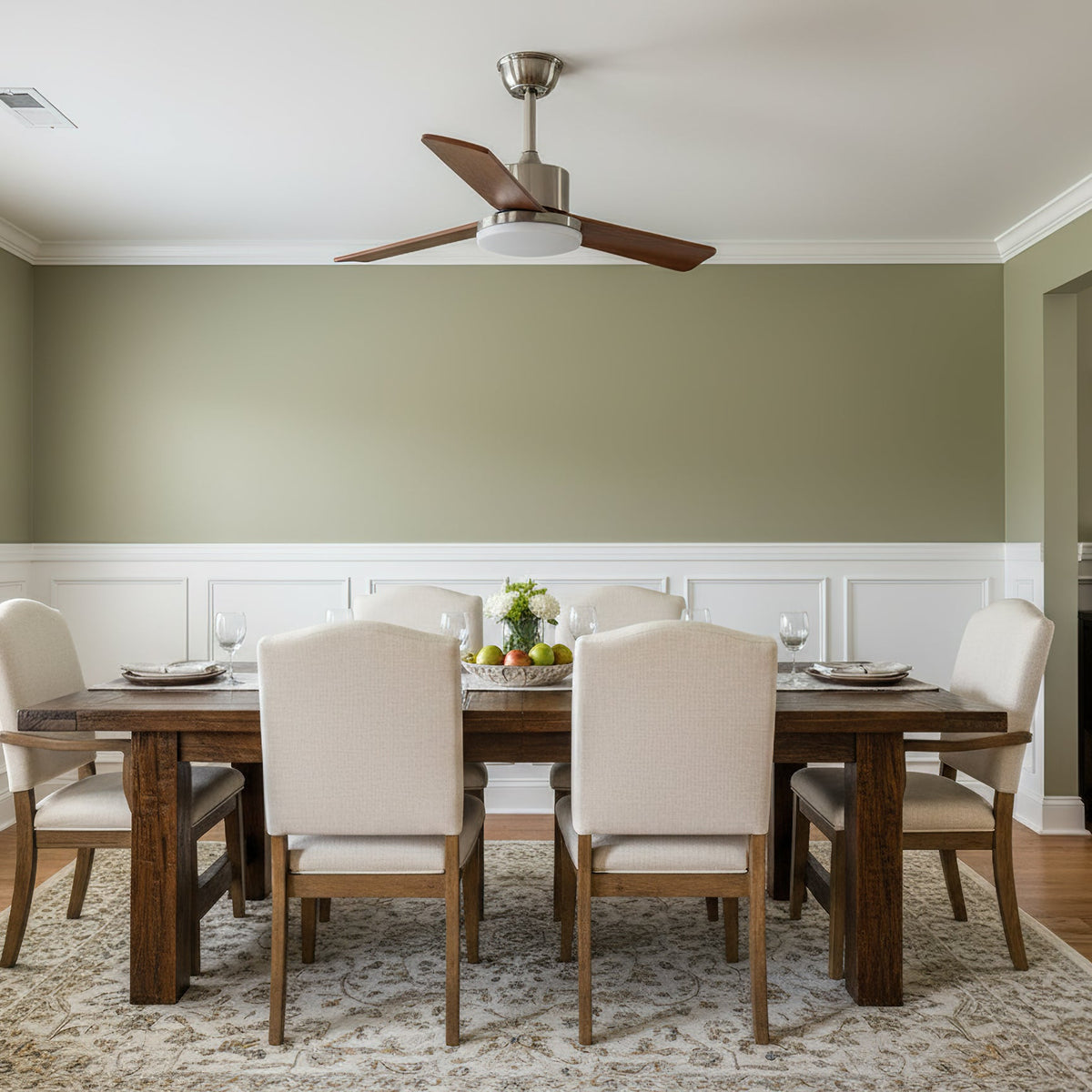 Close-up of the Kendal ceiling fan's chrome motor housing and wood blades.