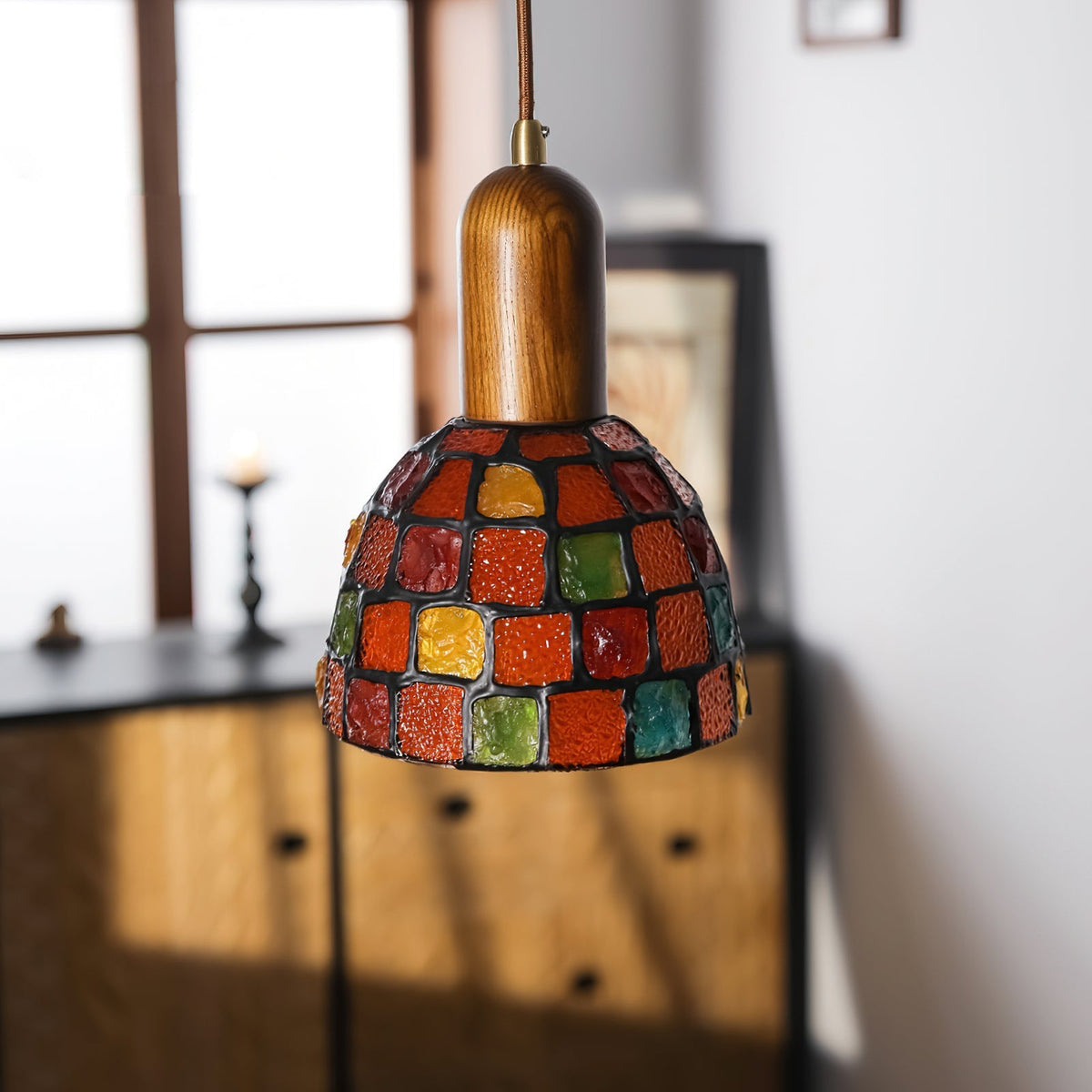 The 3-light linear Klima Pendant Light hanging over a dining table.