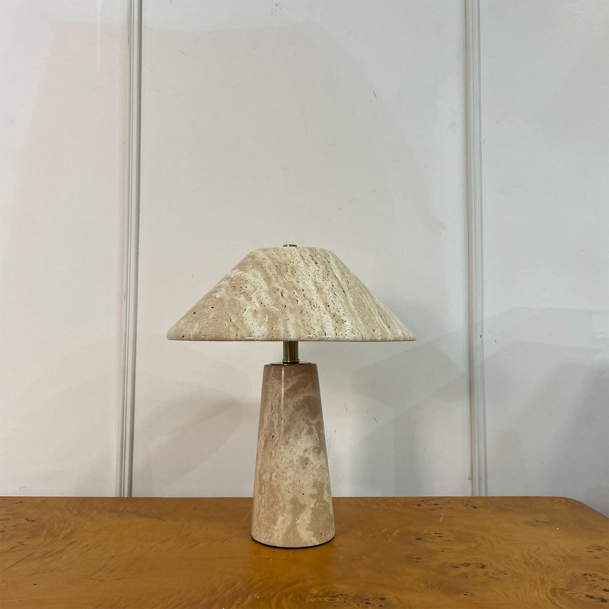 Lydia Table Lamp placed on a wooden side table in a bedroom.