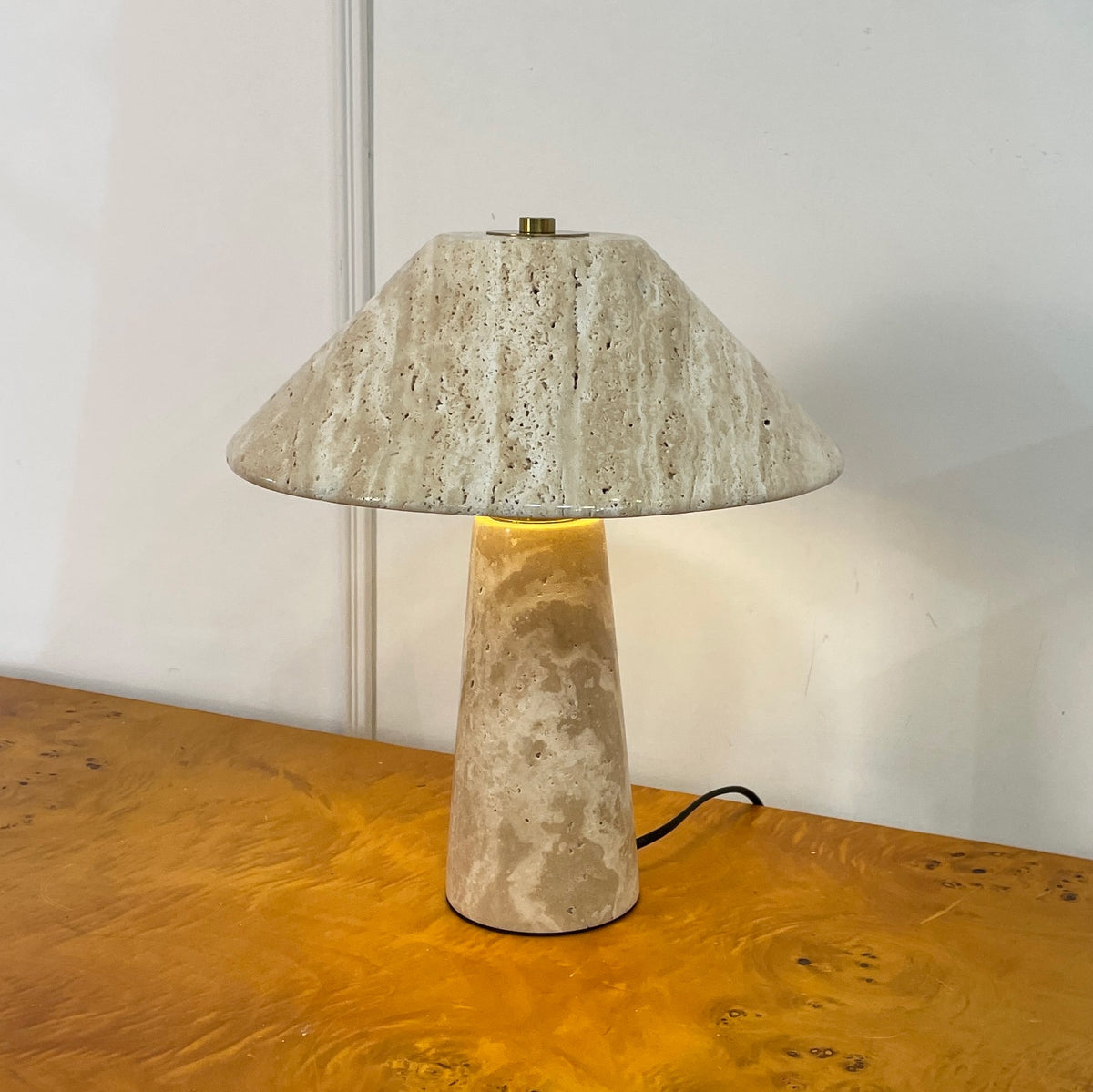 The Lydia Table Lamp turned on, casting a warm glow.