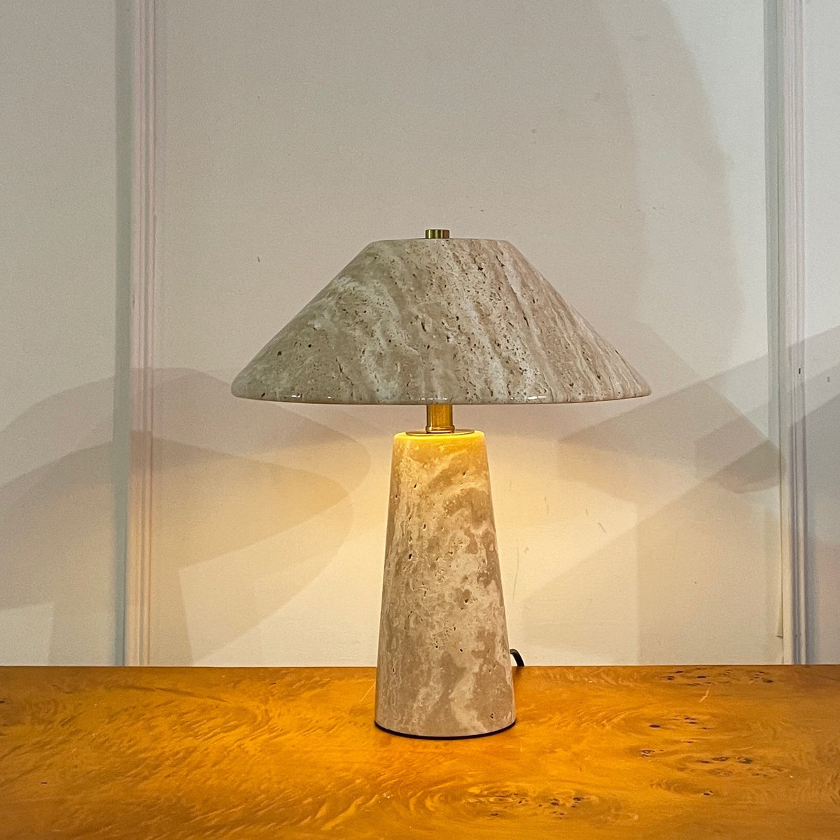 The Lydia Table Lamp against a dark background to showcase its shape.