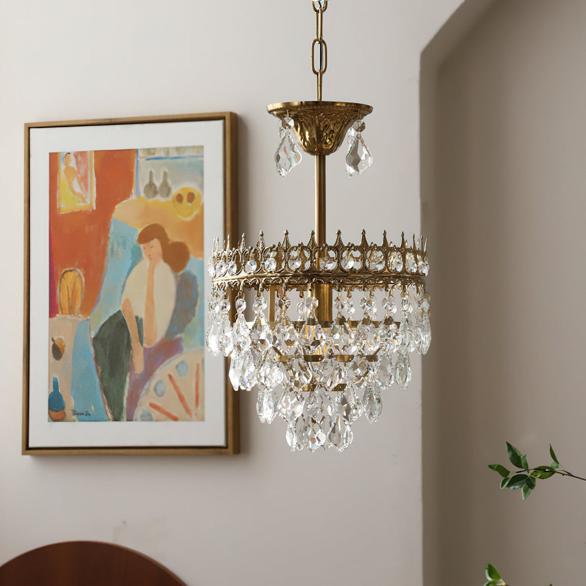 The chandelier casting prismatic light patterns on a nearby wall.